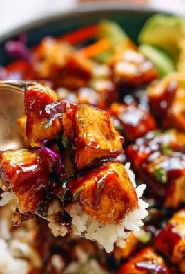 Delicious homemade BBQ Chicken Rice Bowl topped with fresh vegetables