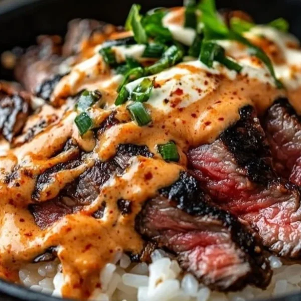 Korean BBQ Steak Rice Bowl with garnishes and colorful ingredients