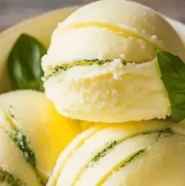 Delicious lemon basil sorbet served in a bowl with fresh basil leaves