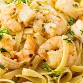 Lemon garlic shrimp pasta served in a bowl with fresh parsley garnish