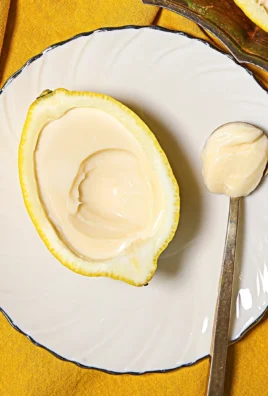 Delicious lemon posset dessert in a glass with a lemon garnish