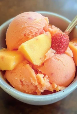 Delicious Mango Strawberry Sorbet served in a bowl with fresh fruits