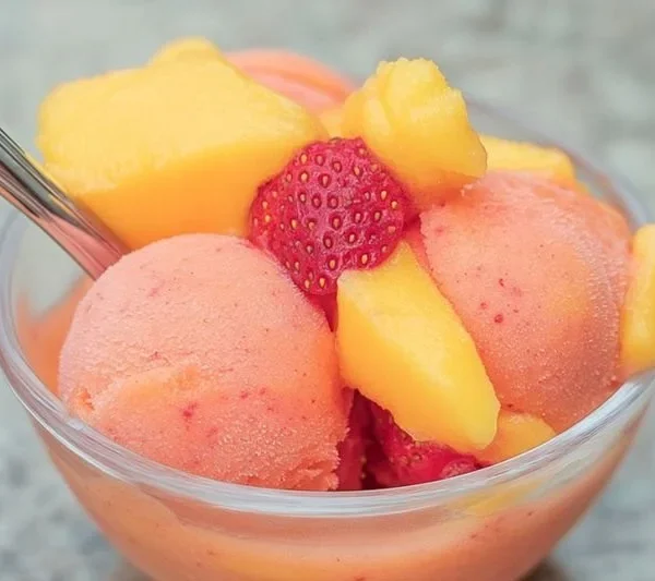 Delicious Mango Strawberry Sorbet served in a bowl with fresh fruits