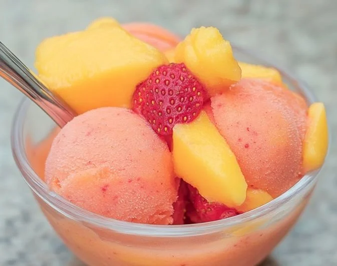 Delicious Mango Strawberry Sorbet served in a bowl with fresh fruits