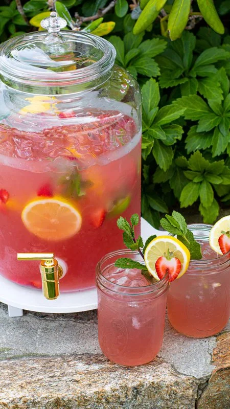 Sparkling lemonade punch in a glass with lemon slices and mint garnish