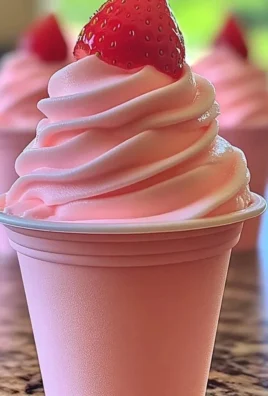 Delicious Strawberry Dole Whip served in a cup.