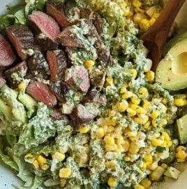 Summer steak and grilled corn salad on a plate with fresh vegetables