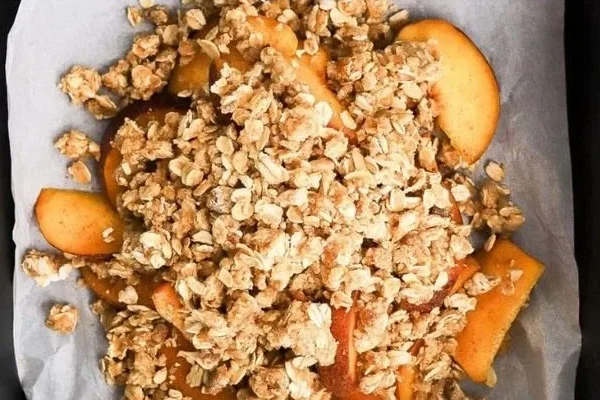 Delicious Air Fryer Peach Crisp served in a bowl with cinnamon topping
