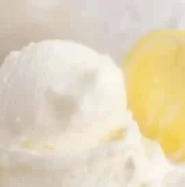 Delicious homemade lemon gelato served in a bowl with fresh lemons