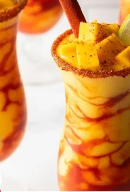 A colorful Chamoyada ice treat with fruit and chamoy sauce served in a cup.