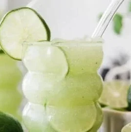 Refreshing Crazy Limeade Slush in a glass with lime slices