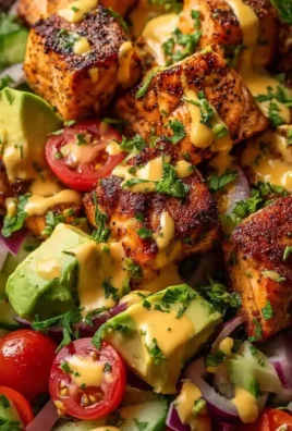 Creamy Bang Bang Salmon Salad with fresh ingredients in a bowl