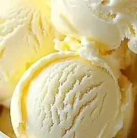 Bowl of creamy lemon ice cream with lemon slices on top