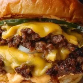 Crispy smash burger with lacy edges and secret sauce on a wooden table