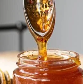 Bottle of easy homemade hot honey with chili peppers
