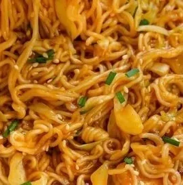 Bowl of easy sweet spicy noodles topped with fresh vegetables