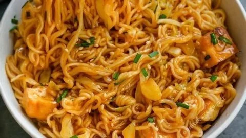 Bowl of easy sweet spicy noodles topped with fresh vegetables