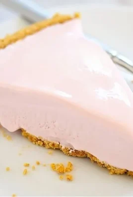 Frozen Pink Lemonade Pie served in a colorful dish with lemon garnish