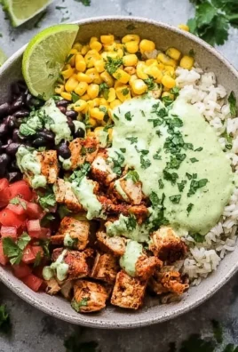 High protein chicken burrito bowl topped with fresh ingredients