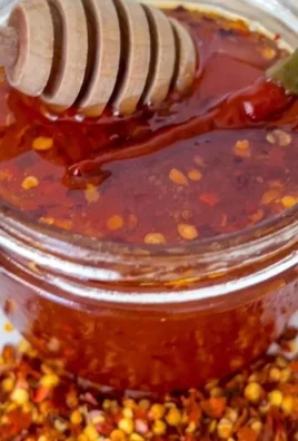 Jar of hot honey with a drizzle, perfect for adding spice and sweetness to dishes.