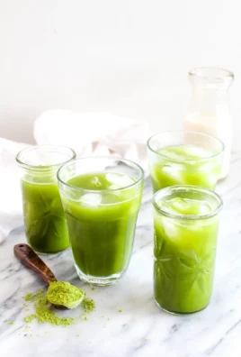 Iced Coconut Water Matcha Latte in a glass with a green straw