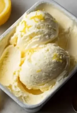 Bowl of creamy Meyer Lemon Gelato topped with lemon zest and mint leaves