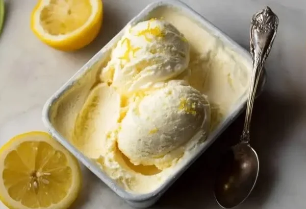 Bowl of creamy Meyer Lemon Gelato topped with lemon zest and mint leaves