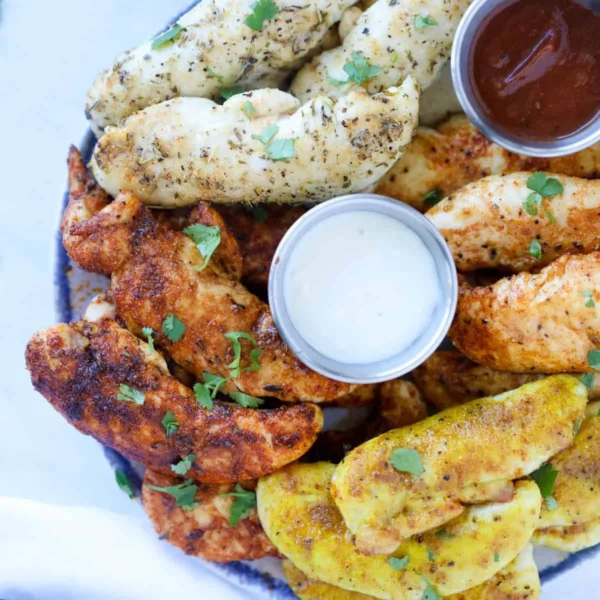 No breading chicken tenders cooked in an air fryer, served on a plate.