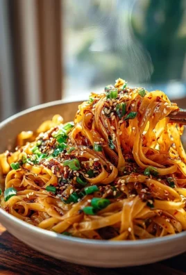Plate of Spicy Garlic Chili Oil Noodles with vibrant garlic and chili oil topping