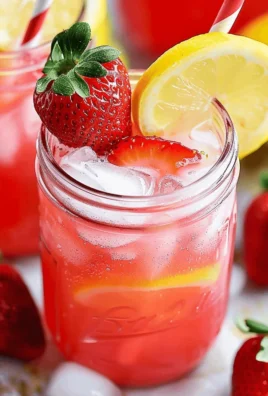 Refreshing Strawberry Coconut Water Lemonade in a glass with strawberries and coconut slices.