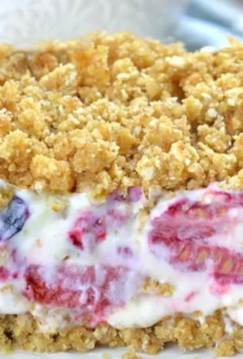 Summer berry frozen dessert topped with fresh berries and mint leaves.