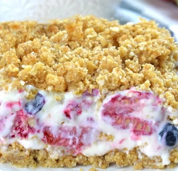 Summer berry frozen dessert topped with fresh berries and mint leaves.