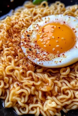 Bowl of sweet and spicy ramen noodles garnished with vegetables and herbs