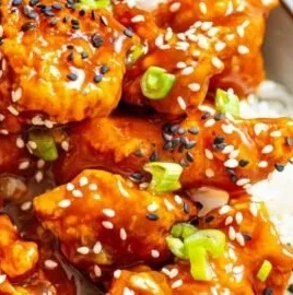 Air Fryer Orange Chicken served with rice and vegetables