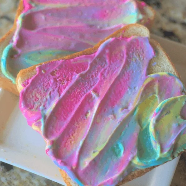 Colorful breakfast unicorn toast topped with vibrant fruit and natural ingredients.