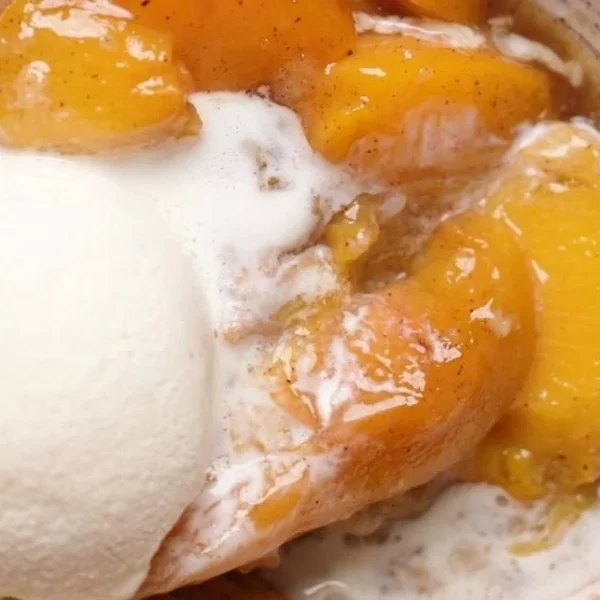 Freshly baked easy Southern peach cobbler in a rustic setting