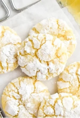 Freshly baked Lemon Crinkle Cookies dusted with powdered sugar