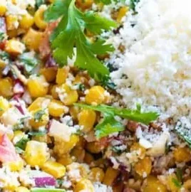 Mexican street corn salad served in a bowl with fresh toppings and cilantro.