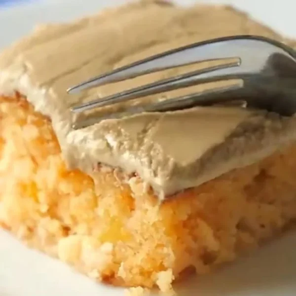 Delicious peach cake with brown sugar frosting on a decorative plate